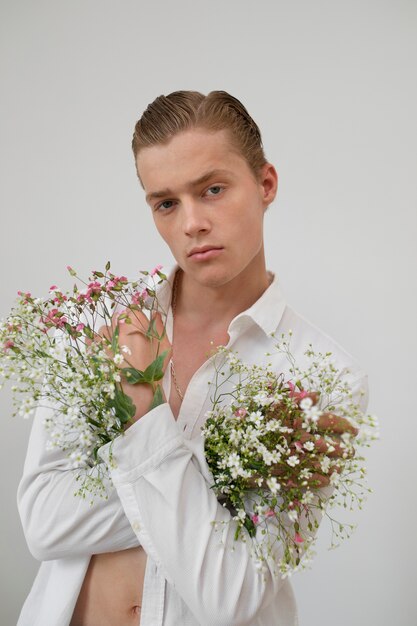 Man with flowers posing medium shot