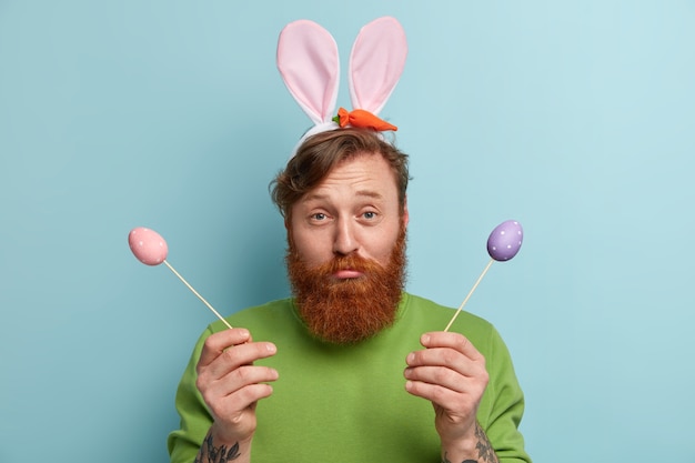 Man with ginger beard wearing colorful clothes and bunny ears