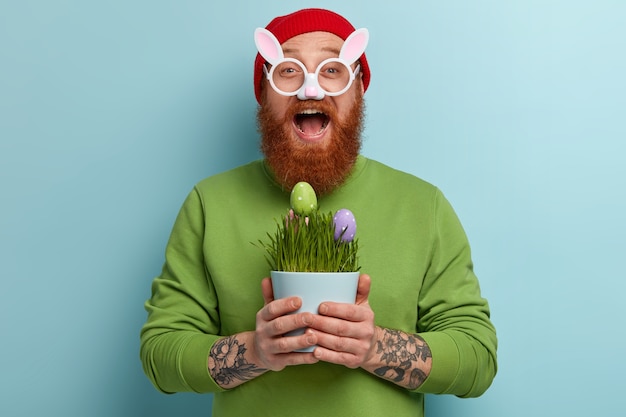 Free Photo man with ginger beard wearing colorful clothes and bunny glasses