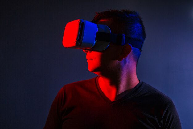 The man with glasses of virtual reality on black isolated background. 