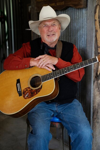 Man with guitar getting ready for country music concert