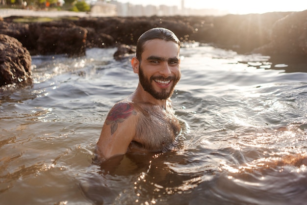 Man with hairy chest at seaside