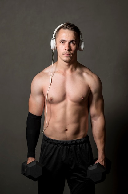 Man with headphones and weights