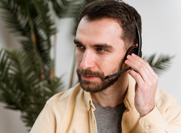 Man with headset having video call on laptop