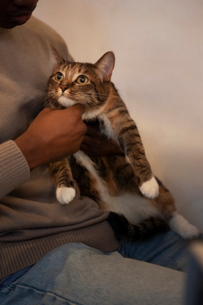 Free Photo man with his adorable pet cat