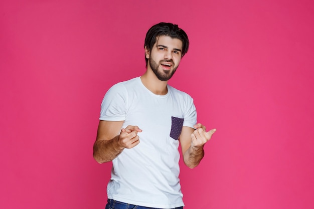 Man with joyful face feels high confidence and enjoys the moment. 