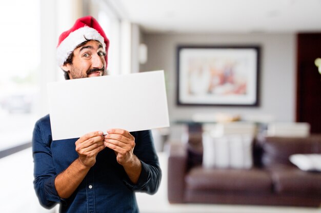 Man with a large sign in a house