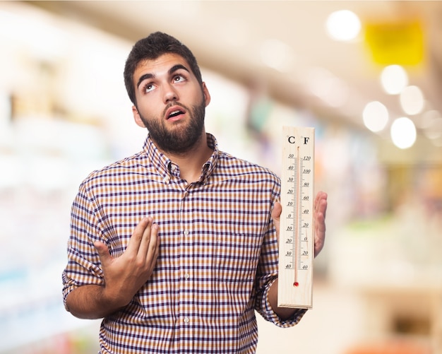 Man with a large thermometer in a hand