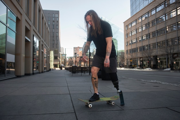 Man with leg disability skateboarding in the city