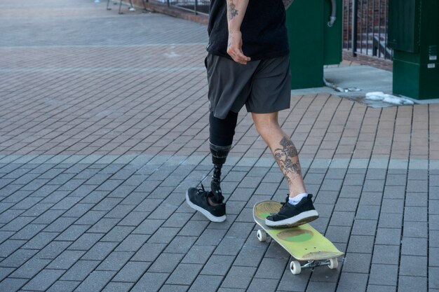 Man with leg disability skateboarding in the city