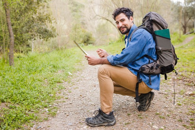 Man with map on path