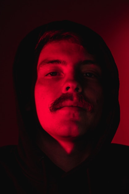 Man with moustache and wearing hoodie