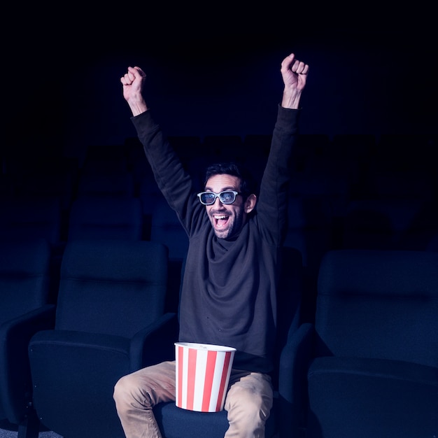 Man with popcorn in cinema