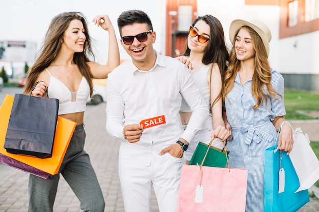 Man with sale tag and his girlfriends