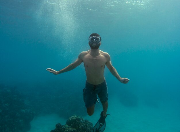 Man with scuba gear swimming in the ocean