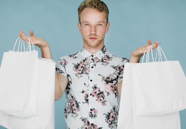 Man with shopping bags on a blue background