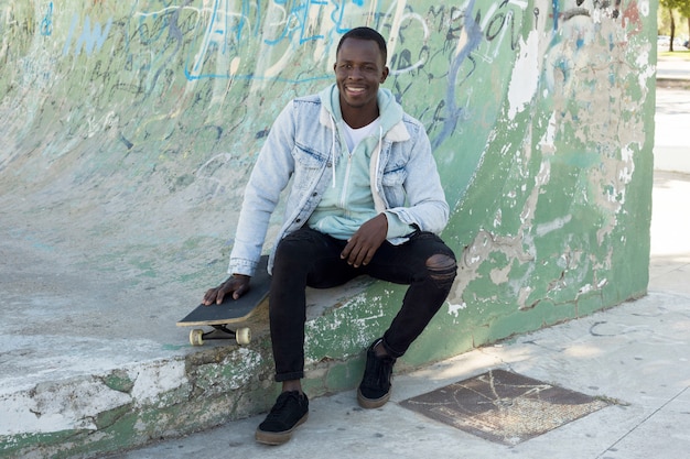 Man with skateboard in urban environment