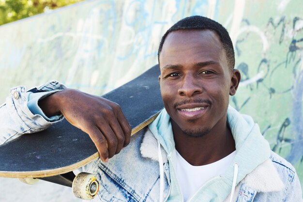 Man with skateboard in urban environment