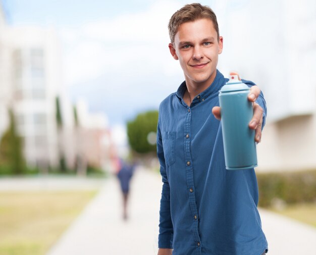 Man with a spray can in a hand