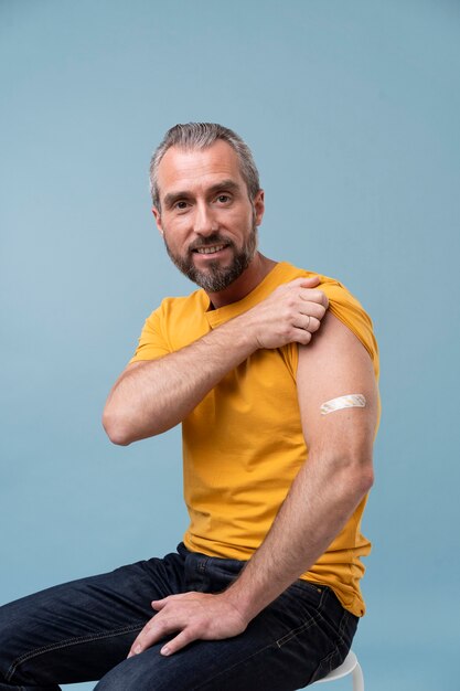 Man with sticker on arm after getting a vaccine