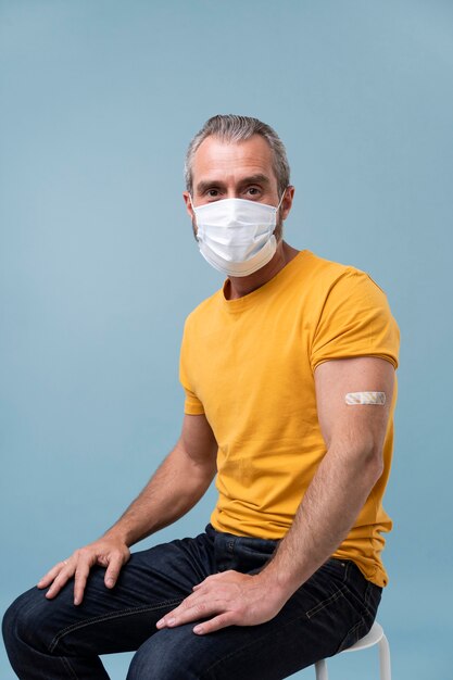 Man with sticker on arm after getting a vaccine