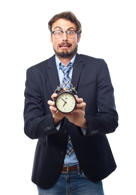 Free photo man with suit holding an alarm clock