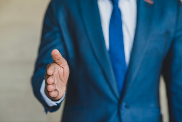 Free photo man with suit reaching out hand