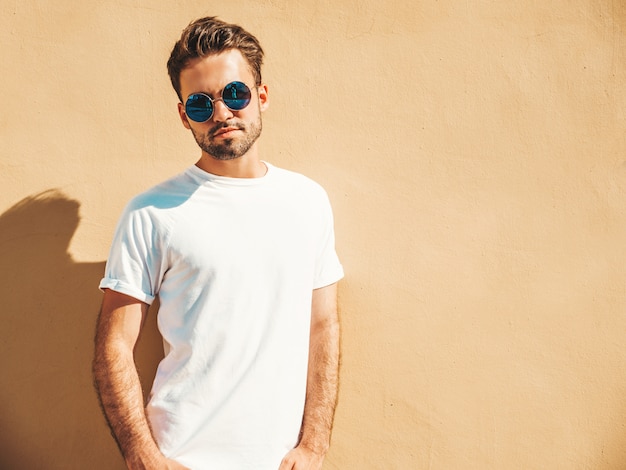 Man with sunglasses wearing white t-shirt posing