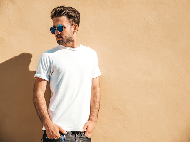 Man with sunglasses wearing white t-shirt posing