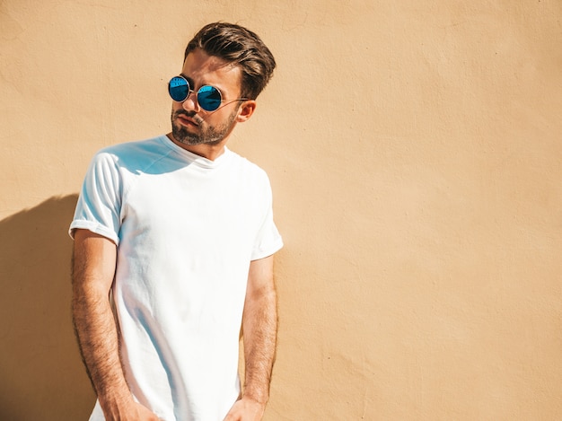 Man with sunglasses wearing white t-shirt posing