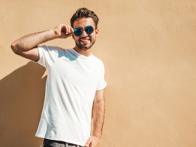 Man with sunglasses wearing white t-shirt posing