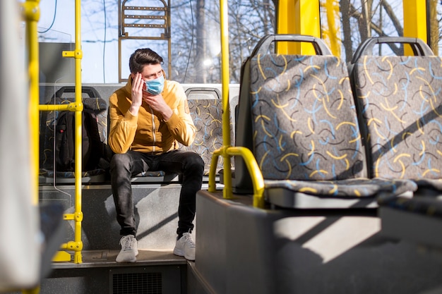 Free Photo man with surgical mask in public transport