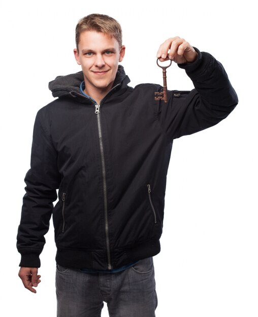 Man with sweatshirt holding an old key