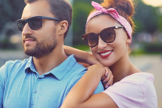 A man with tattoos on his arms and a redheaded woman on a date.