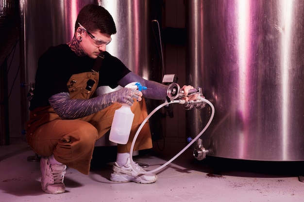 Man with tattoos producing craft beer