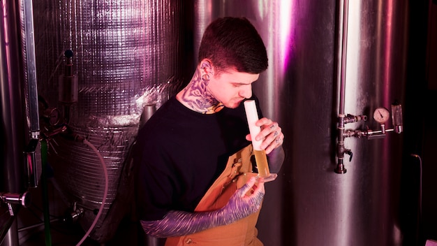 Free Photo man with tattoos producing craft beer