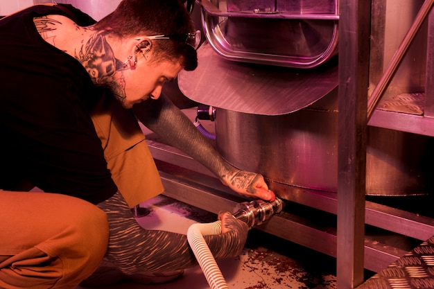 Man with tattoos producing craft beer