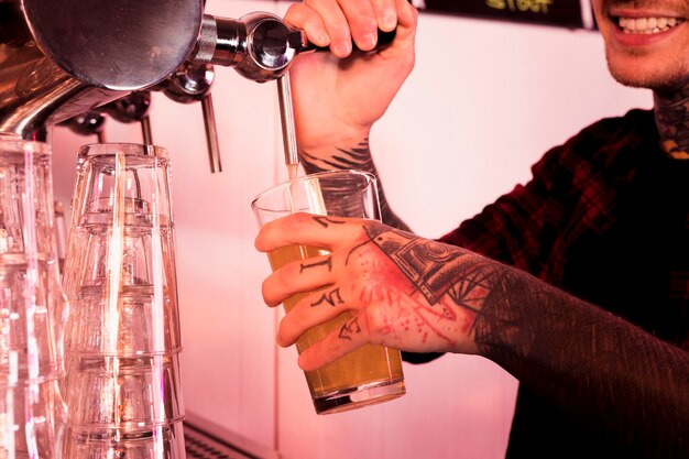 Man with tattoos producing craft beer