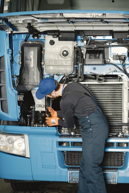 Free Photo man with tools for truck. worker in uniform. faulty truck