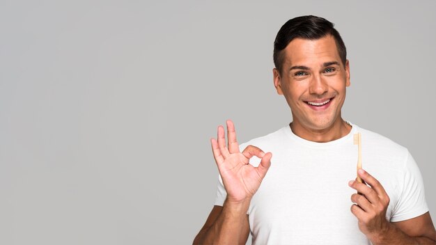 Man with toothbrush showing approval