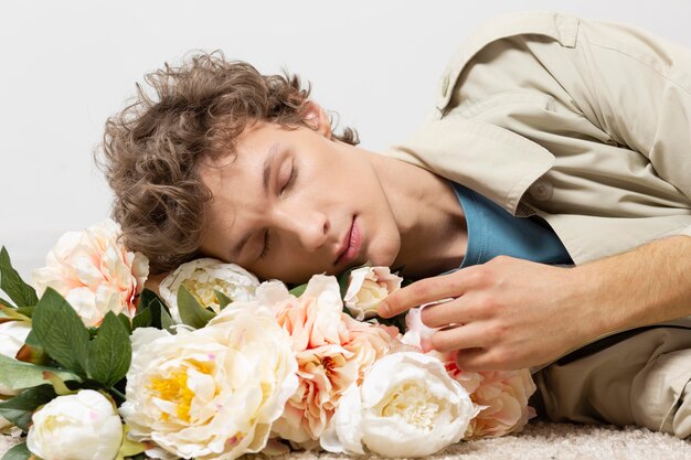 Man with trench coat holding flowers