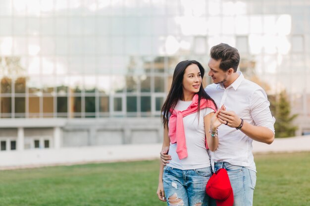 Man with trendy haircut gently holding friend's hand