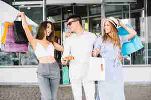 Free photo man with two women holding sale label