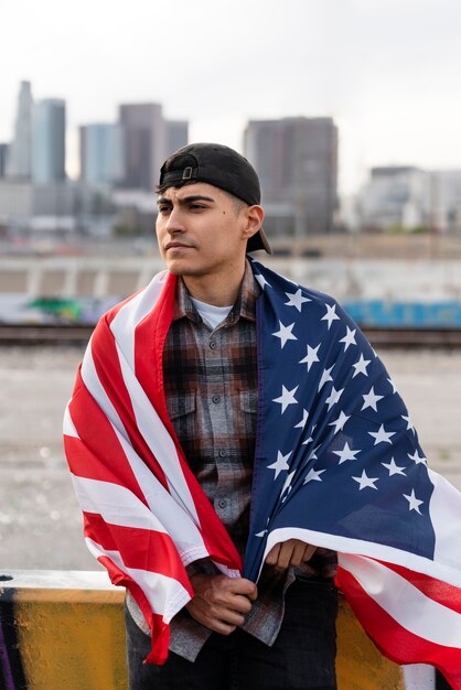 Man with usa flag next to the river