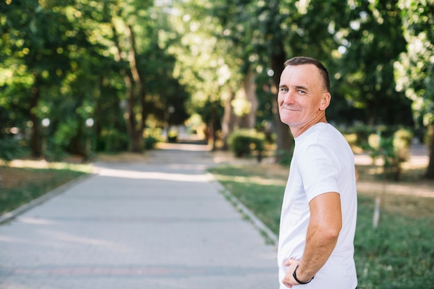 Man with white t-shirt looking to camera