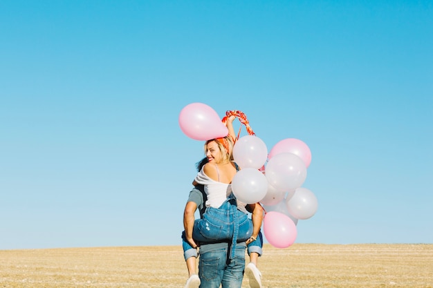 Free Photo man with woman on his back