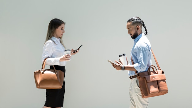 Man and woman being addicted to their phones even outdoors