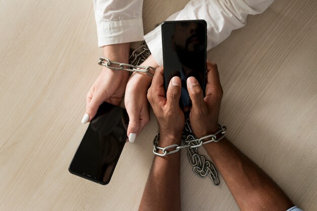 Man and woman being addicted to their phones even at work