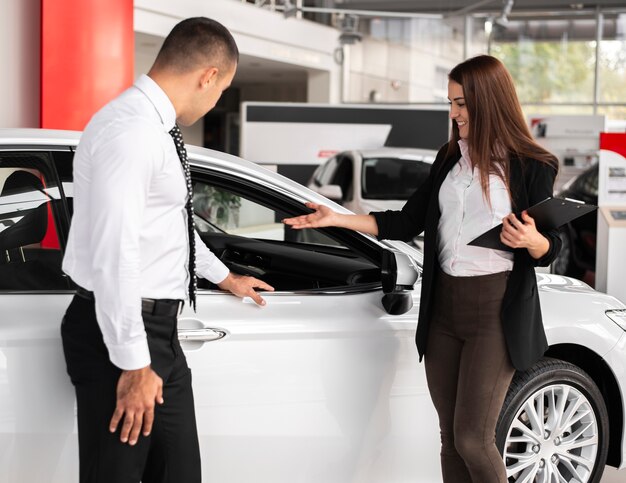 Man and woman at a car dealership