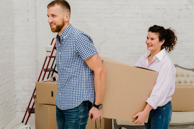 Man and woman carrying box